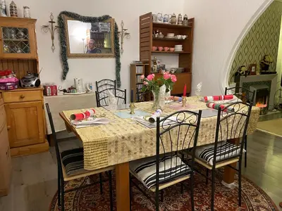 a dining room with a table with chairs and a mirror at Renovated 4-Bed Home Sleeps 9 with Parking & Spa in Blackpool