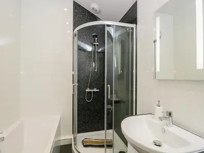 a bathroom with a shower and a sink at Little Barn in Grange Over Sands