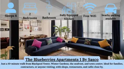 a living room with two blue couches with different pillows at Blueberries Apartments by Sasco in Blackpool