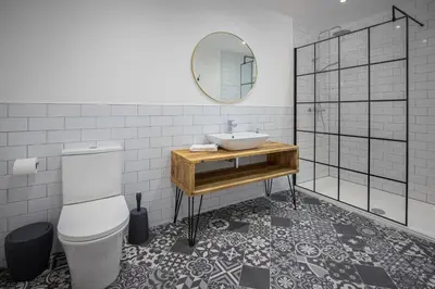 a bathroom with a sink and a toilet and a mirror at Blueberries Apartments by Sasco in Blackpool