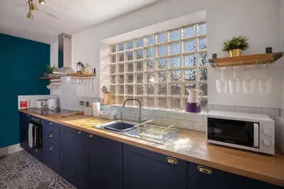 a kitchen with a sink and a microwave on a counter at Blueberries Apartments by Sasco in Blackpool