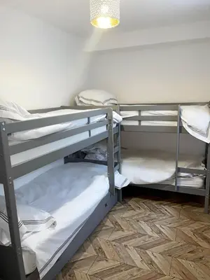 a room with three bunk beds in a room at Smith Stayz Apartments in Blackpool