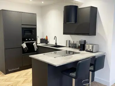 a kitchen with a counter with a sink and a microwave at Smith Stayz Apartments in Blackpool