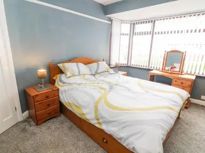 a bedroom with a bed with a dresser and a mirror at 71 Nutter Road in Cleveleys