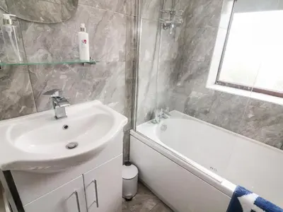 a bathroom with a sink and a bath tub at 71 Nutter Road in Cleveleys