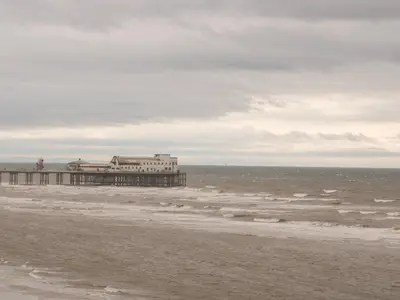 a pier on the beach with the ocean at 71 Nutter Road in Cleveleys