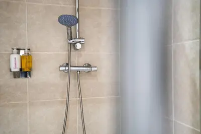 a shower with a shower head in a bathroom at Huge 7 Bed Home For Groups in Liverpool