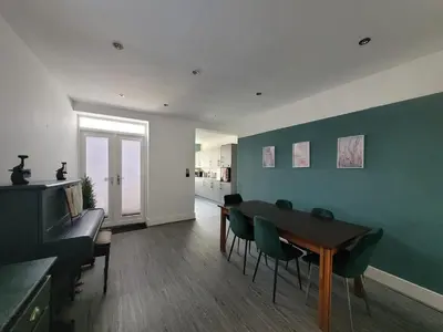 a living room with a dining room table and chairs at Ideal Lodgings in Accrington in Accrington