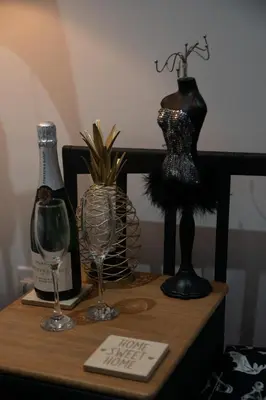 a table with a bottle of wine and two glasses at Ideal Lodgings in Accrington in Accrington