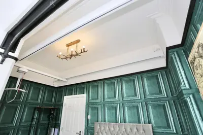 a room with green walls and a white ceiling at The Hot Tub Townhouse by Holiday Heim in Lytham St Annes