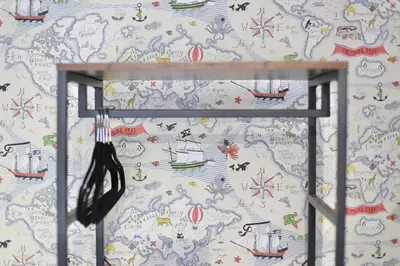 a room with a wall with a wallpaper with drawings of boats at The Hot Tub Townhouse by Holiday Heim in Lytham St Annes