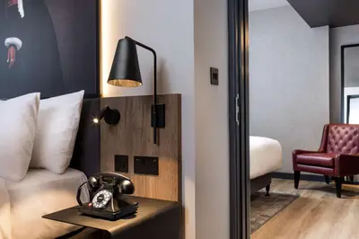 a hotel room with a bed and a phone on a table at Radisson RED Hotel, Liverpool in Liverpool