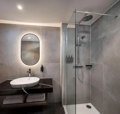 a bathroom with a sink and a shower at Radisson RED Hotel, Liverpool in Liverpool