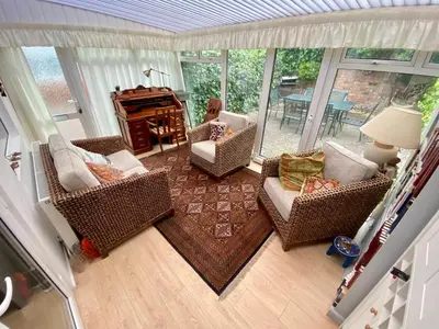 an aerial view of a living room with chairs and a piano at Spacious Two Bedroom House - TM in Southport