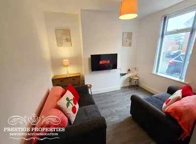 a living room with a couch and a tv at Cross Street by Prestige Properties SA in Barrow in Furness