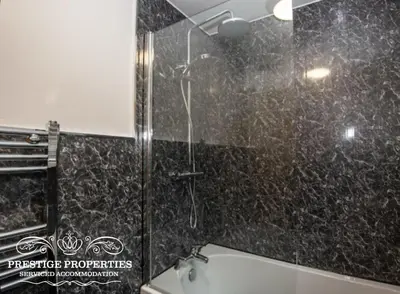 a bathroom with a shower and a bath tub at Cross Street by Prestige Properties SA in Barrow in Furness