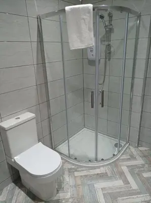 a bathroom with a shower with a toilet and a glass shower stall at Rose James Apartments in Blackpool