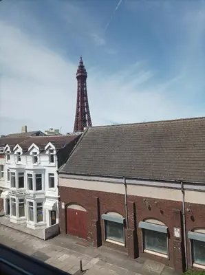 a view of a building with a tower in the background at Rose James Apartments in Blackpool