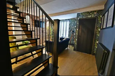 a hallway with a spiral staircase in a house at Boutique cottage set in historic town of Clitheroe in Clitheroe