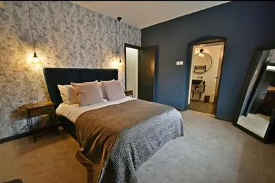 a bedroom with a large bed in a room at Boutique cottage set in historic town of Clitheroe in Clitheroe