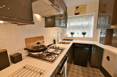 a kitchen with a stove with a pot on it at Boutique cottage set in historic town of Clitheroe in Clitheroe