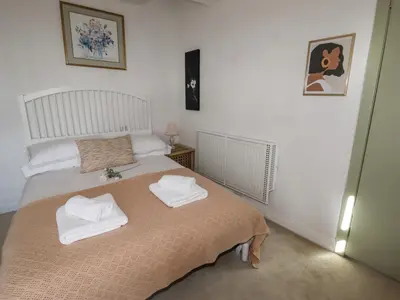 a bedroom with two white towels on a bed at 112 Balmoral Road in Morecambe