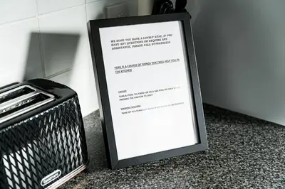 a sign sitting on a counter next to a suitcase at warm modern 3 bedroom house free secure off road parking, wifi & sky sleep upto 6 guest 2 bathrooms in Aintree