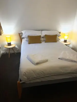 a large bed with two lamps on two tables at Princess Gardens Liverpool Accessible - Infinity in Liverpool