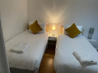 two twin beds in a small room with a lamp at Princess Gardens Liverpool Accessible - Infinity in Liverpool