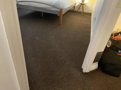 a bedroom with a bed and a hallway with carpet at Princess Gardens Liverpool Accessible - Infinity in Liverpool