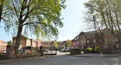 a parking lot with a gate in front of a building at Princess Gardens Liverpool Accessible - Infinity in Liverpool