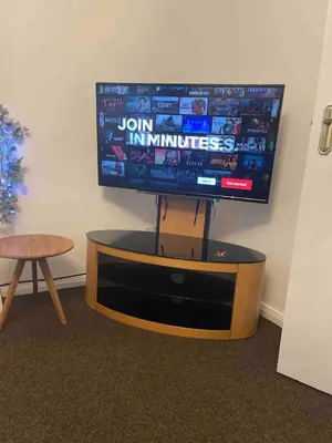 a flat screen tv sitting on a stand in a room at Princess Gardens Liverpool Accessible - Infinity in Liverpool