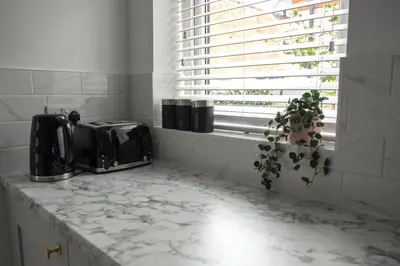 a kitchen counter with a toaster and a window at The Callie by Sasco Apartments in Blackpool