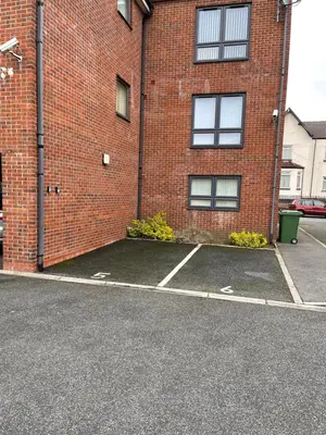 an empty parking lot in front of a brick building at Modern, Quiet, Sleeps 10, Anfield, Tourists, Liverpool in Liverpool