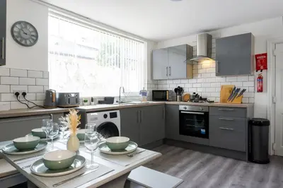 a kitchen with a table with bowls on it at Coningsby House - Air Host & Stay - 6BR, Sleeps 14 in Liverpool