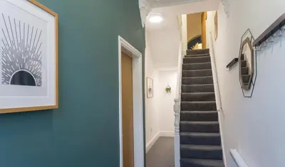 a staircase in a house with blue walls at Coningsby House - Air Host & Stay - 6BR, Sleeps 14 in Liverpool