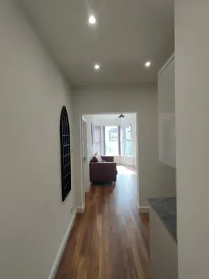 a living room with a couch and wooden floors at Lovely refurbished apartments, Morecambe Promenade in Morecambe