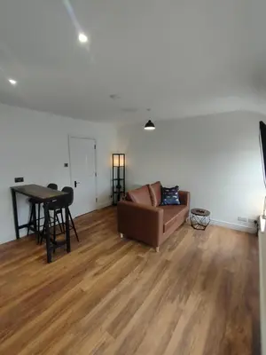 a living room with a couch and a table at Lovely refurbished apartments, Morecambe Promenade in Morecambe