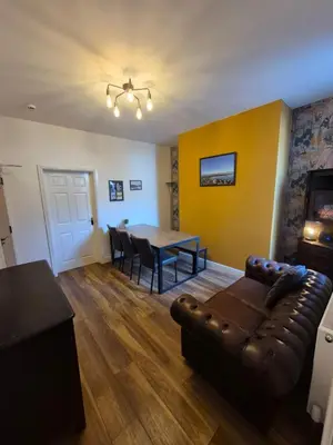 a living room with a couch and a table at Lovely refurbished apartments, Morecambe Promenade in Morecambe