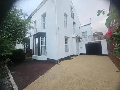 a white house with a driveway in front of it at The Chestnut - Liverpool City - L7 in Liverpool