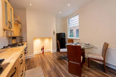 a kitchen with a table and chairs in a room at The Chestnut - Liverpool City - L7 in Liverpool