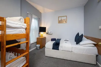 a bedroom with a bed and a bunk bed at Royal Oakwell Hotel in Blackpool