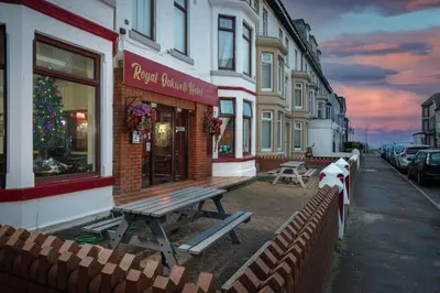 a restaurant with a picnic bench outside of a building at Royal Oakwell Hotel in Blackpool