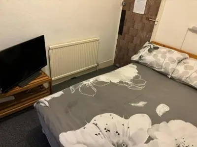a bedroom with a bed with a flower painted on it at Argyll guest house in Blackpool
