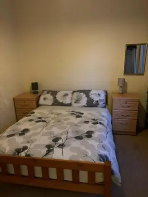 a bedroom with a bed and two nightstands and a bed sidx sidx sidx at Argyll guest house in Blackpool