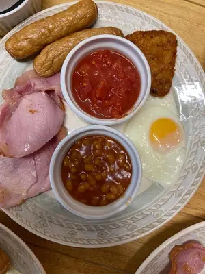 a plate of food with eggs sausage beans and toast at Argyll guest house in Blackpool