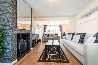 a living room with a white couch and a fireplace at *Superb Location* Large 4 Bedroom City Centre Home in Liverpool