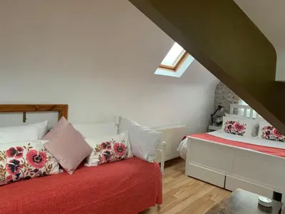a bedroom with a bed with pillows and a window at Brenda & Petes in Birkenhead