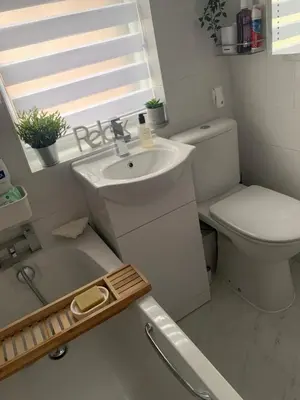 a white bathroom with a sink and a toilet at Brenda & Petes in Birkenhead