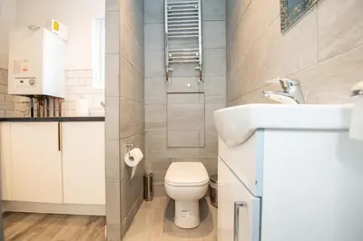 a small bathroom with a toilet and a sink at Five Seasons Liverpool City - Modern Studios near Anfield in Liverpool